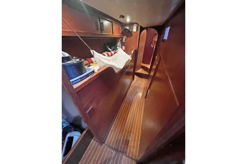 Slide: The Image of Interior of a 1979 Amel Mango sailboat with wooden flooring and storage. - 38