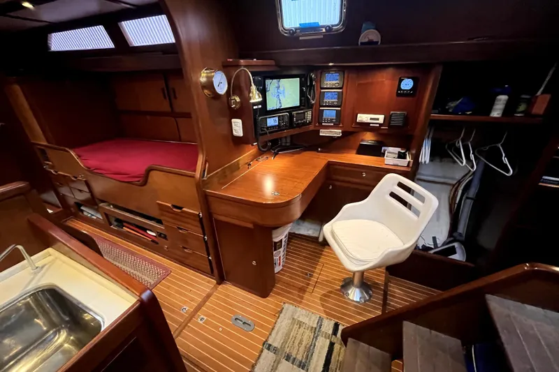 Slide: The Image of 1979 Amel Mango yacht interior with navigation station and cozy cabin. - 44