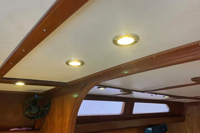 Slide: The Image of Interior of 1979 Amel Mango yacht with wooden paneling and recessed lighting. - 48