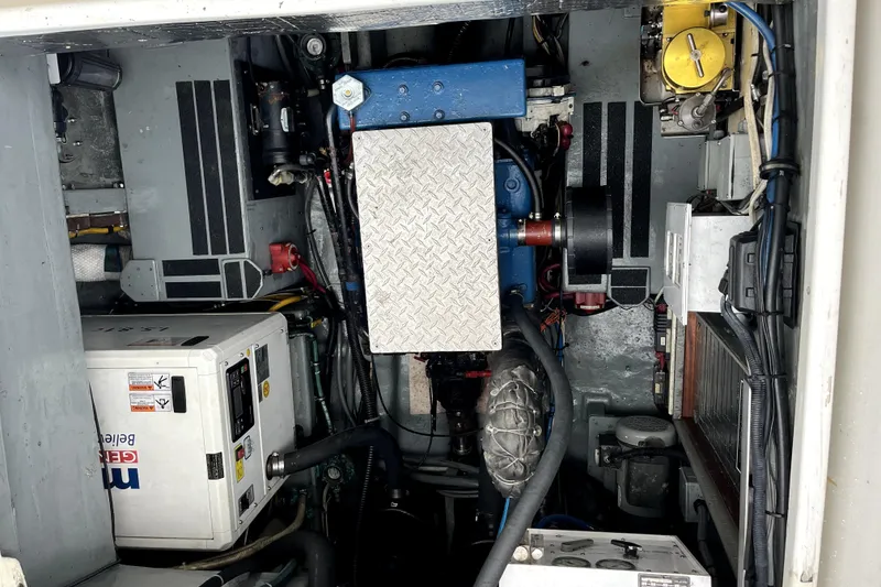 Slide: The Image of Engine room of a 1979 Amel Mango sailboat, showcasing mechanical components and wiring. - 50