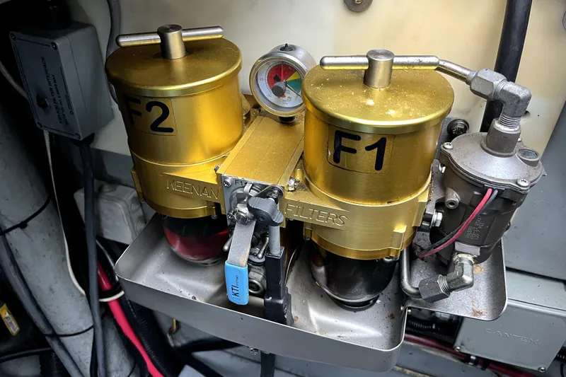 Slide: The Image of Engine room of 1979 Amel Mango yacht with dual fuel filters and pressure gauge. - 52
