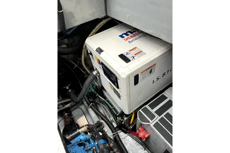 Slide: The Image of Engine room of a 1979 Amel Mango sailboat featuring a generator. - 53