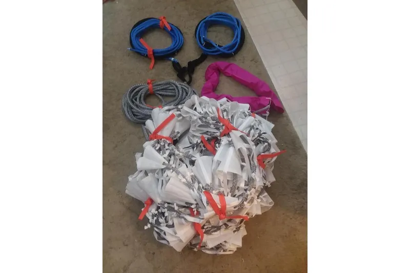 Slide: The Image of Assorted ropes and chains on a floor, including blue, gray, and pink colors. - 55