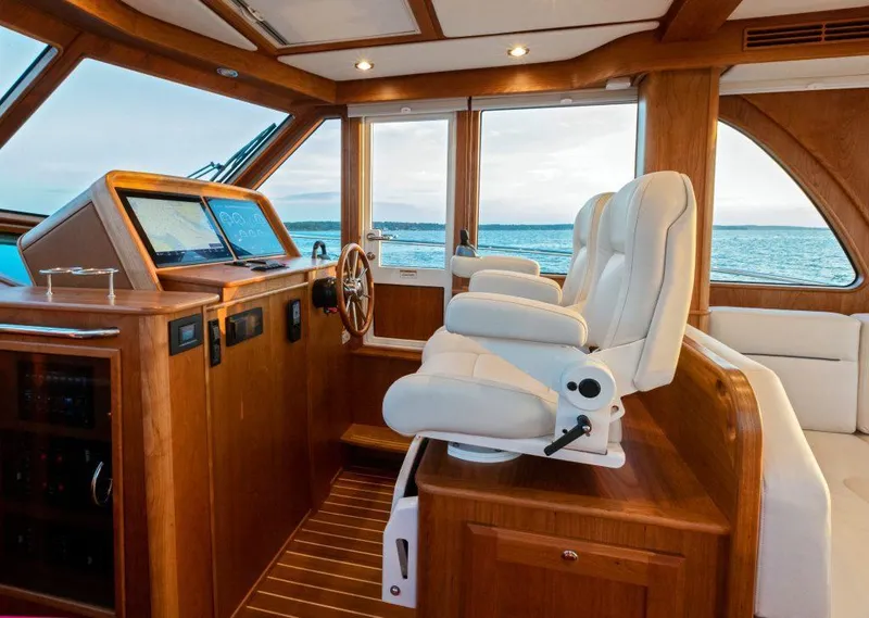 Slide: The Image of Interior of 2026 Sabre 43 Salon Express yacht with luxurious seating and navigation controls. - 16
