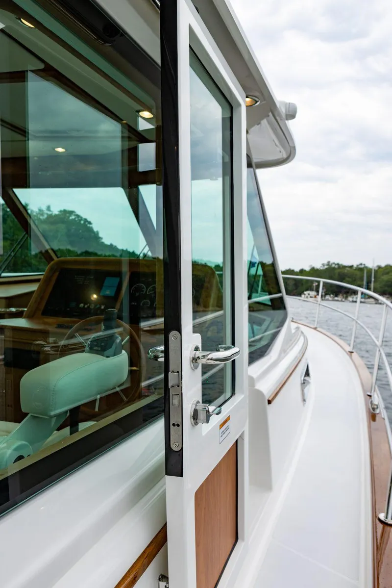 Slide: The Image of 2026 Sabre 43 Salon Express yacht with open door, showcasing sleek design and luxurious interior. - 8