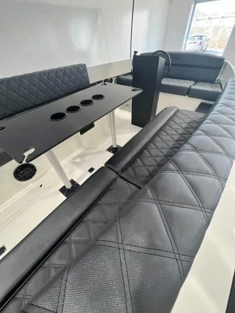Slide: The Image of Interior of 2023 Vision Marine Technologies Fantail 217 with black quilted seating and table. - 3