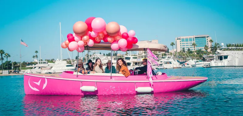 Slide: The Image of Pink Vision Marine Fantail 217 boat with balloons, cruising in a marina, 2023 model. - 7
