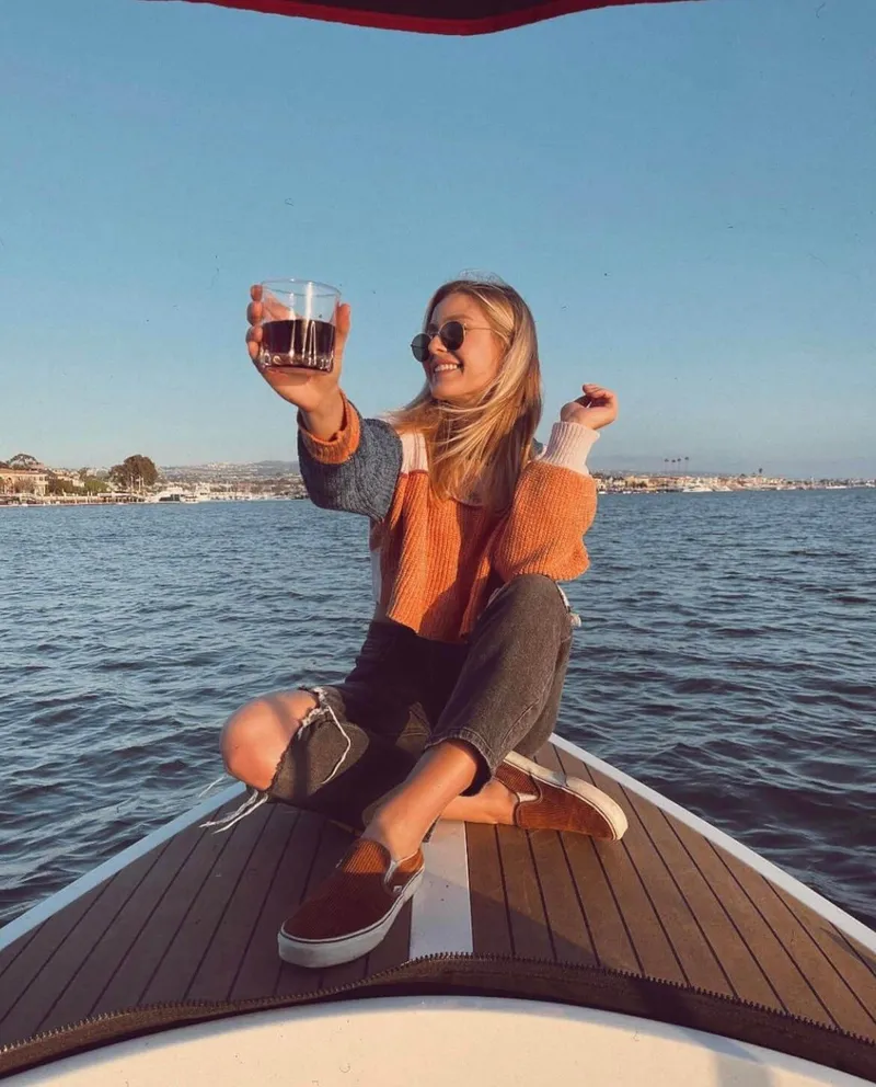 Slide: The Image of Woman enjoying a drink on a 2023 Vision Marine Fantail 217 boat. - 8