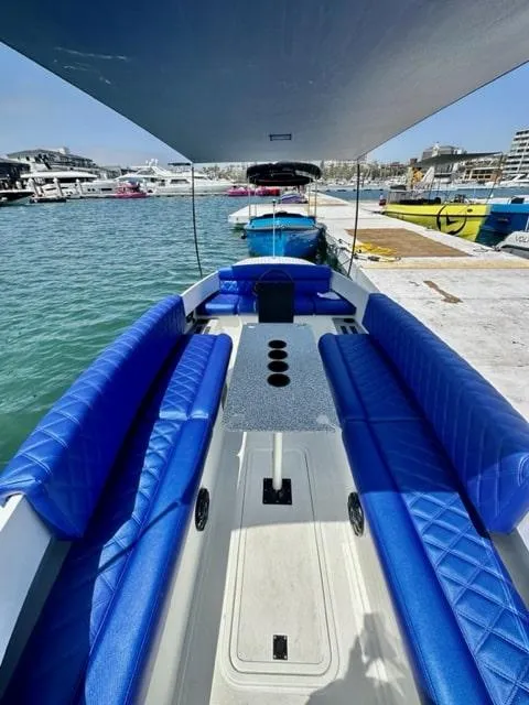 Slide: The Image of 2023 Vision Marine Technologies Fantail 217 boat with blue seating at a marina. - 5