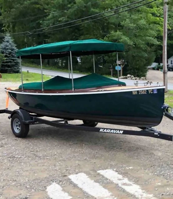 The Image of 2020 Vision Marine Technologies Fantail 217 boat on trailer, green canopy, parked outdoors. - 0