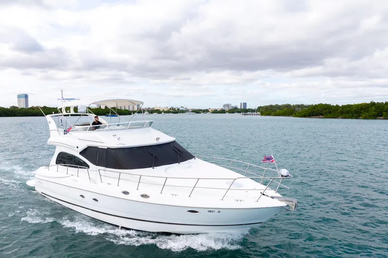 Slide: The Image of 2001 Cruisers Yachts 5000 Sedan Sport cruising on a scenic waterway. - 10