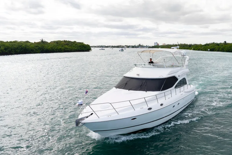 Slide: The Image of 2001 Cruisers Yachts 5000 Sedan Sport cruising on a scenic waterway. - 12