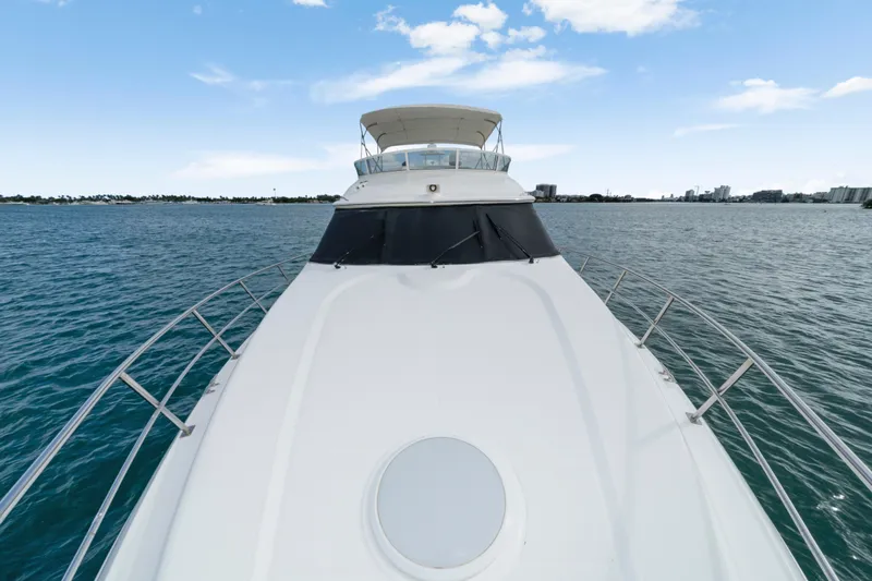 Slide: The Image of 2001 Cruisers Yachts 5000 Sedan Sport on open water, clear sky background. - 18