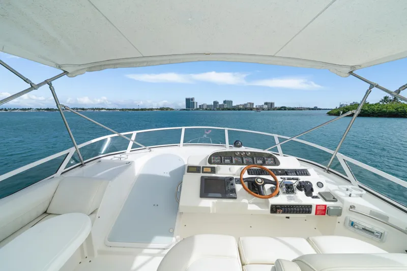 Slide: The Image of 2001 Cruisers Yachts 5000 Sedan Sport helm with ocean view and city skyline. - 24