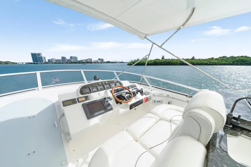 Slide: The Image of 2001 Cruisers Yachts 5000 Sedan Sport helm with ocean view and city skyline. - 26