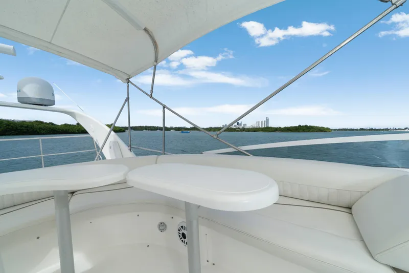 Slide: The Image of 2001 Cruisers Yachts 5000 Sedan Sport, white seating, ocean view, clear sky, modern design. - 29