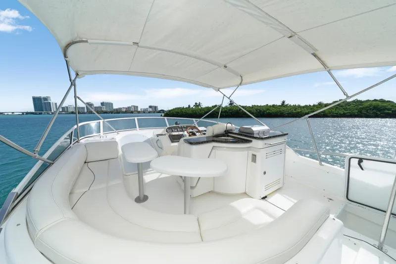 Slide: The Image of 2001 Cruisers Yachts 5000 Sedan Sport interior with seating and helm, overlooking water and cityscape. - 34