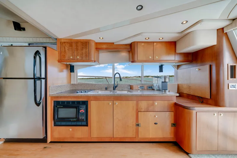 Slide: The Image of Luxurious kitchen interior of 2001 Cruisers Yachts 5000 Sedan Sport with modern appliances. - 37