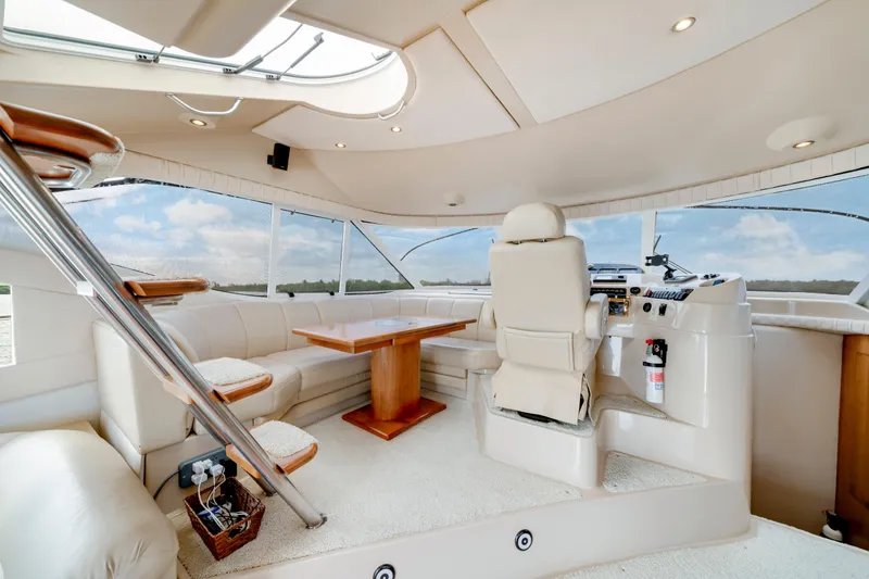 Slide: The Image of Luxurious interior of 2001 Cruisers Yachts 5000 Sedan Sport with plush seating and helm. - 47