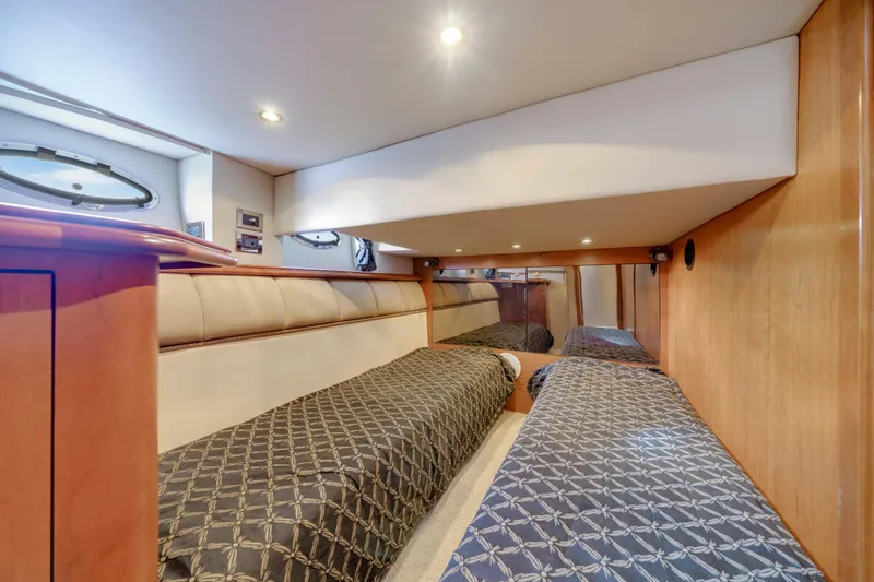 Slide: The Image of Interior cabin of 2001 Cruisers Yachts 5000 Sedan Sport with twin beds and wood paneling. - 50