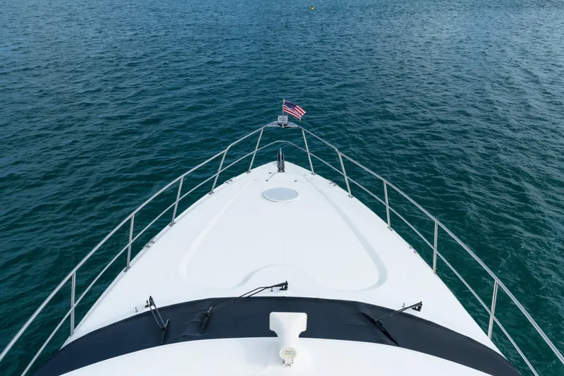 Slide: The Image of Bow view of 2001 Cruisers Yachts 5000 Sedan Sport on open water. - 6