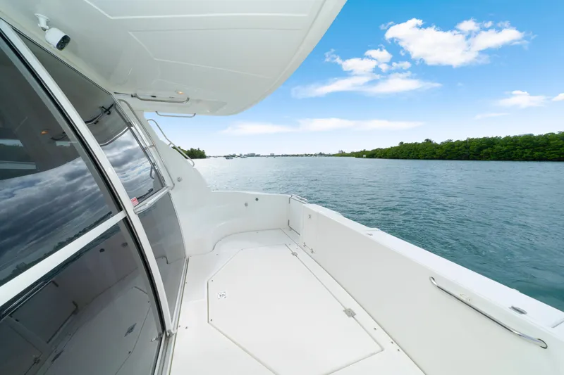 Slide: The Image of 2001 Cruisers Yachts 5000 Sedan Sport on serene water with clear blue sky. - 13