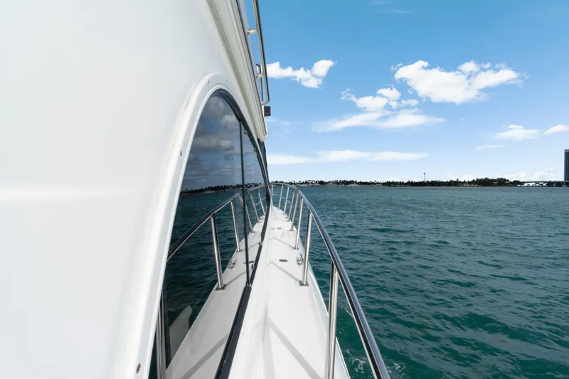 Slide: The Image of Side view of 2001 Cruisers Yachts 5000 Sedan Sport on open water. - 17