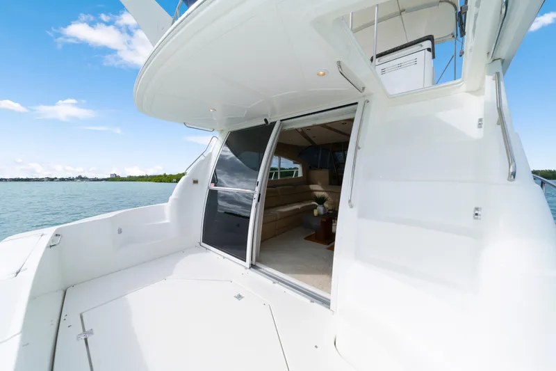 Slide: The Image of 2001 Cruisers Yachts 5000 Sedan Sport, open deck view, luxurious interior, calm waters. - 20