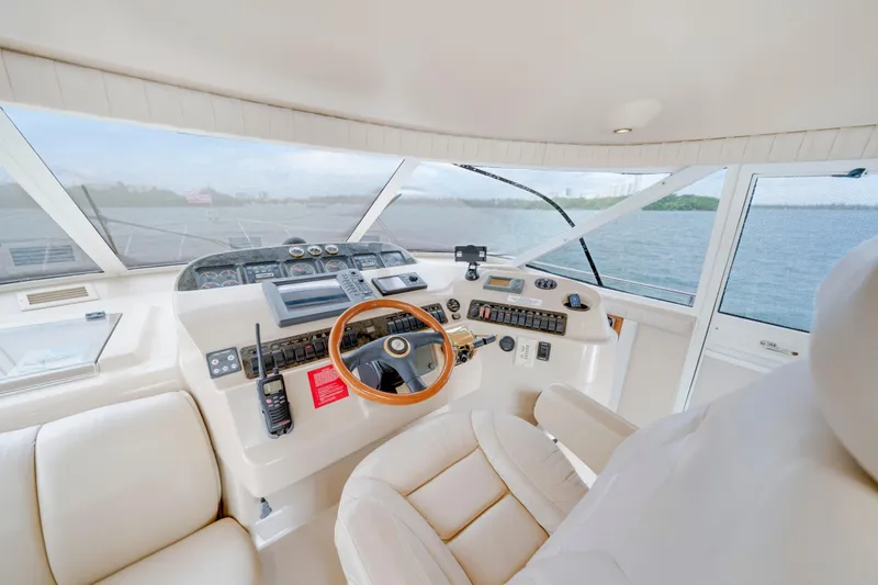 Slide: The Image of 2001 Cruisers Yachts 5000 Sedan Sport helm with luxurious leather seating and panoramic views. - 45