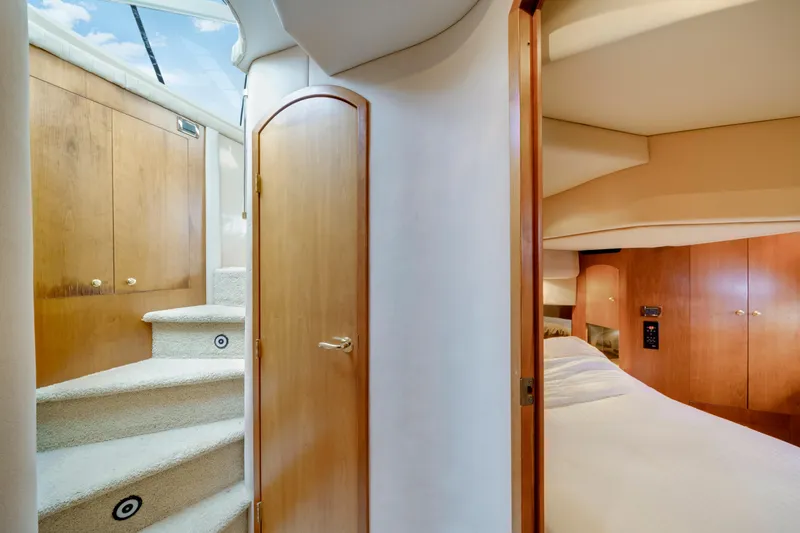 Slide: The Image of Interior of 2001 Cruisers Yachts 5000 Sedan Sport, featuring stairs and cozy bedroom. - 48