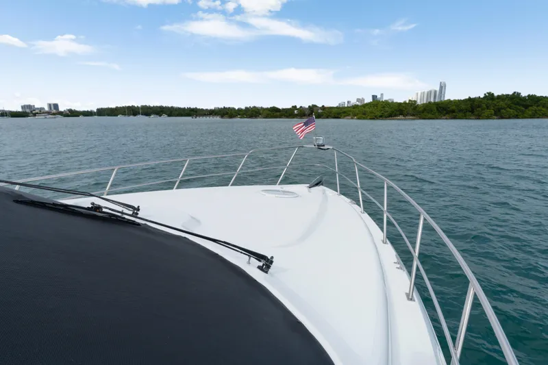 Slide: The Image of 2001 Cruisers Yachts 5000 Sedan Sport on water, city skyline in background. - 7