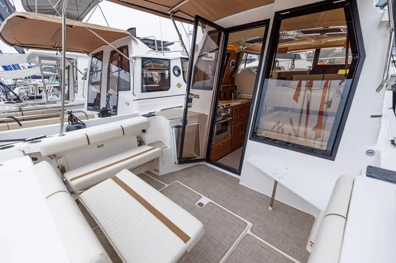 Slide: The Image of 2026 Ranger Tugs R-27 boat interior with seating and kitchenette. - 5