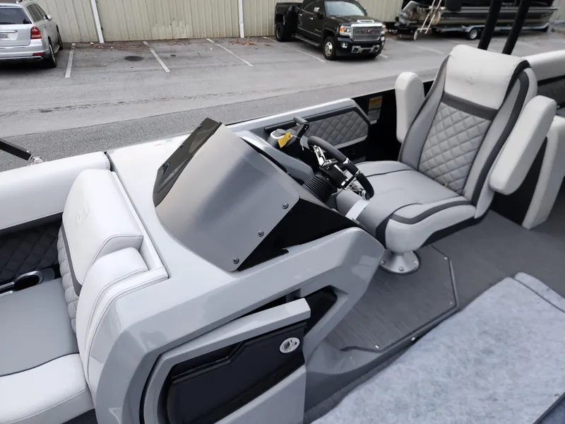 Slide: The Image of 2025 Godfrey AquaPatio Sundeck 275 SDC interior with modern helm and seating. - 11