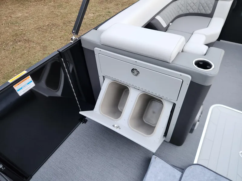 Slide: The Image of 2025 Godfrey AquaPatio Sundeck 275 SDC interior with storage compartments and seating. - 12