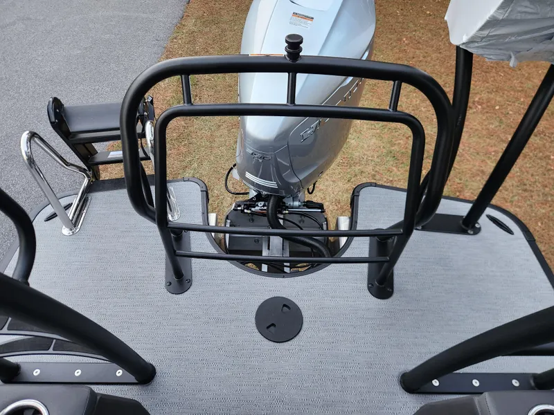 Slide: The Image of 2025 Godfrey AquaPatio Sundeck 275 SDC boat deck with motor and railing. - 13