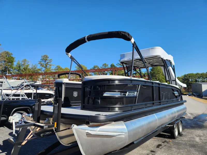 Slide: The Image of 2025 Godfrey AquaPatio Sundeck 275 SDC pontoon boat on trailer, sunny day. - 5