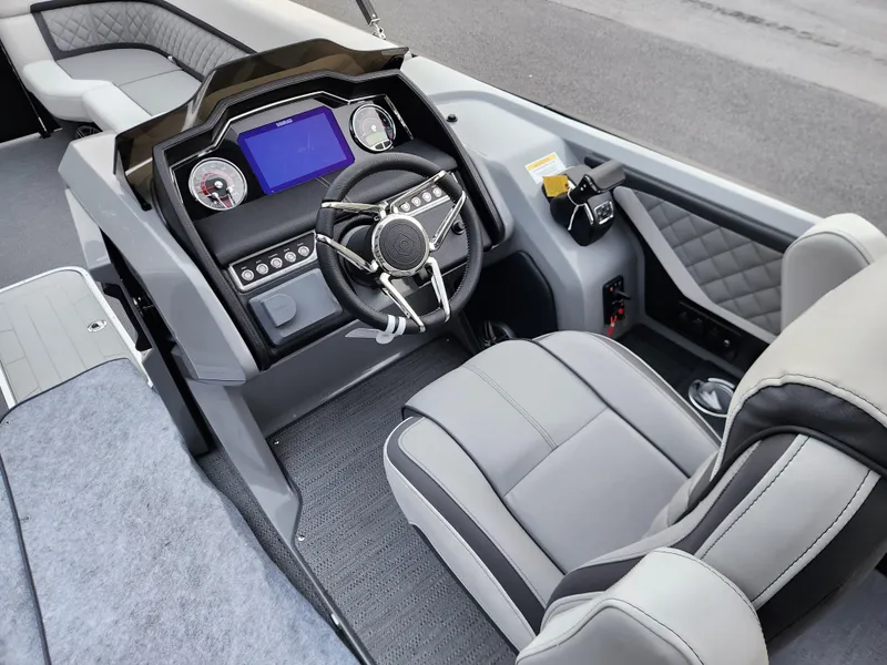 Slide: The Image of 2025 Godfrey AquaPatio Sundeck 275 SDC boat interior with modern steering and dashboard. - 9