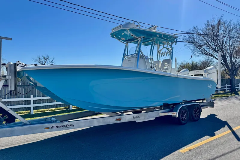 Slide: The Image of 2021 Costa Custom Boats 264 HC on trailer, light blue hull, sunny day. - 1