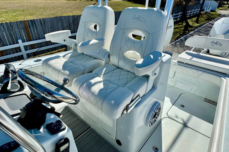 Slide: The Image of Luxurious seating on 2021 Costa Custom Boats 264 HC, featuring plush white upholstery. - 11