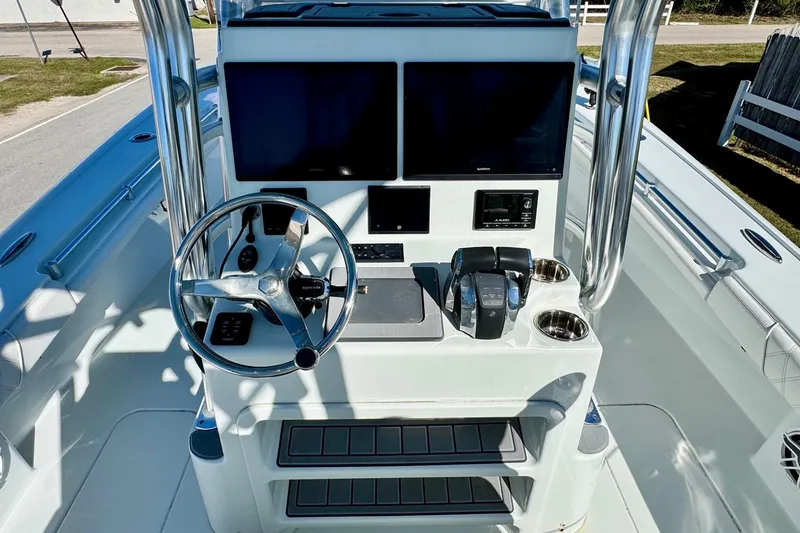 Slide: The Image of 2021 Costa Custom Boats 264 HC helm with dual screens and steering wheel. - 12