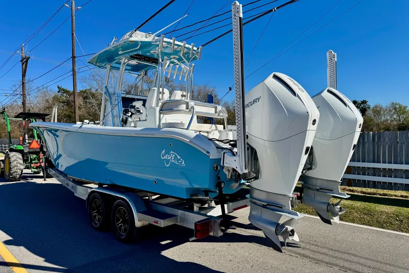 Slide: The Image of 2021 Costa Custom Boats 264 HC with dual Mercury engines on a trailer. - 2