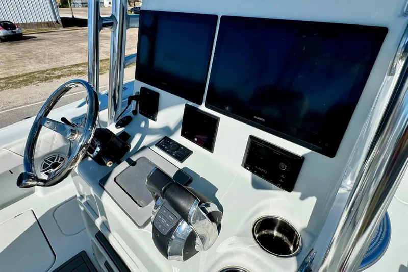 Slide: The Image of 2021 Costa Custom Boats 264 HC helm with dual screens and modern controls. - 21