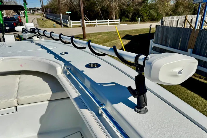 Slide: The Image of 2021 Costa Custom Boats 264 HC with rod holders on deck, parked outdoors. - 22