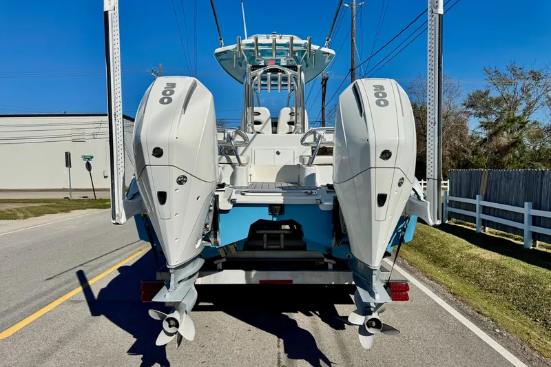 Slide: The Image of 2021 Costa Custom Boats 264 HC with dual outboard engines on a trailer. - 3