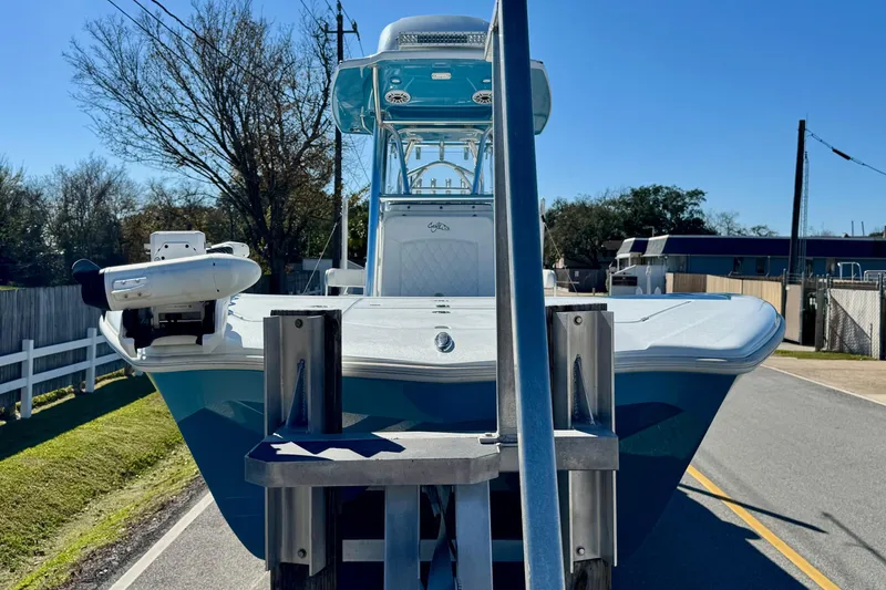 Slide: The Image of 2021 Costa Custom Boats 264 HC on trailer, parked on a sunny street. - 6