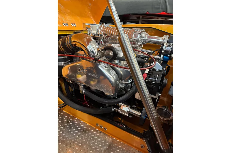 Slide: The Image of Engine of a 2007 Eliminator Daytona 30 boat with chrome components and detailed wiring. - 11