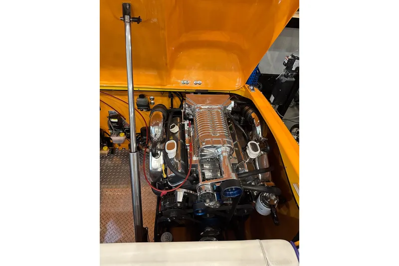 Slide: The Image of 2007 Eliminator Daytona 30 engine compartment with chrome components and orange detailing. - 13