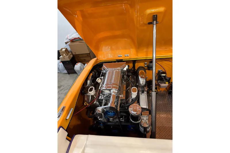 Slide: The Image of 2007 Eliminator Daytona 30 engine compartment with open orange hatch, showcasing powerful motor. - 14