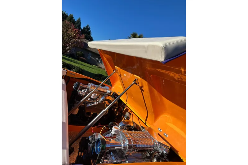 Slide: The Image of 2007 Eliminator Daytona 30 boat engine compartment with vibrant orange exterior. - 17