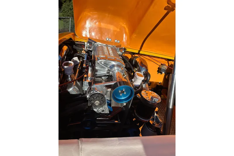 Slide: The Image of 2007 Eliminator Daytona 30 engine with orange hood, showcasing detailed components. - 19